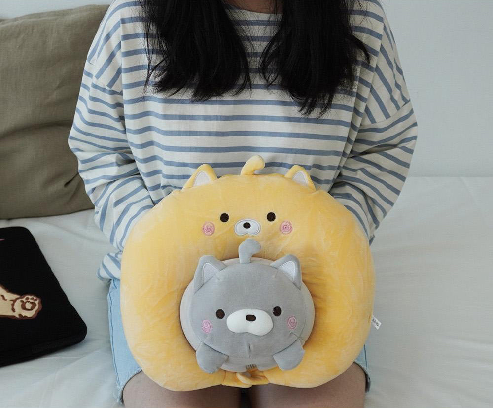 a woman sitting on a bed holding a stuffed animal